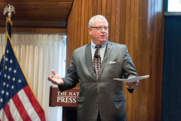 Joe Grace speaks at the National Press Club.